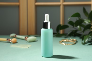 Photo of Bottle of cosmetic product on light blue table