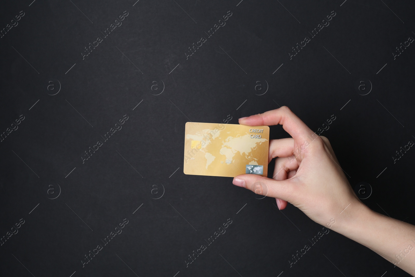 Photo of Woman holding credit card on black background, closeup