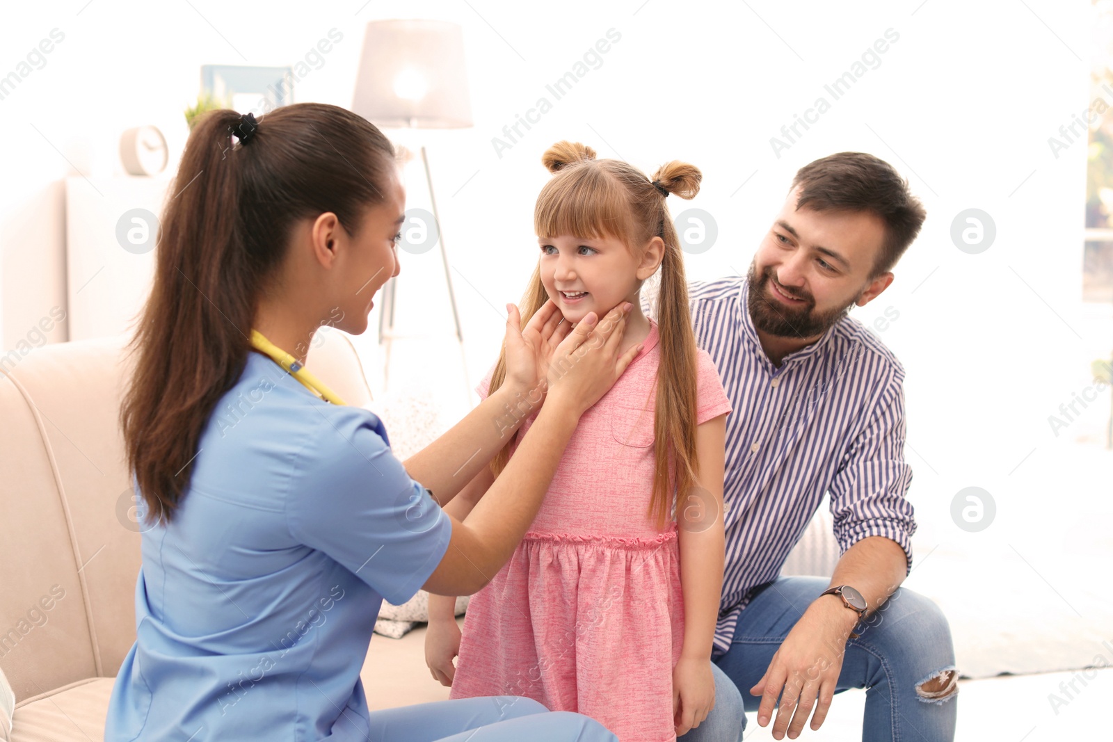 Photo of Children's doctor visiting little girl at home