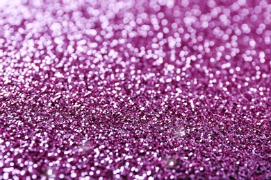 Photo of Texture of rose gold glitter as background, closeup