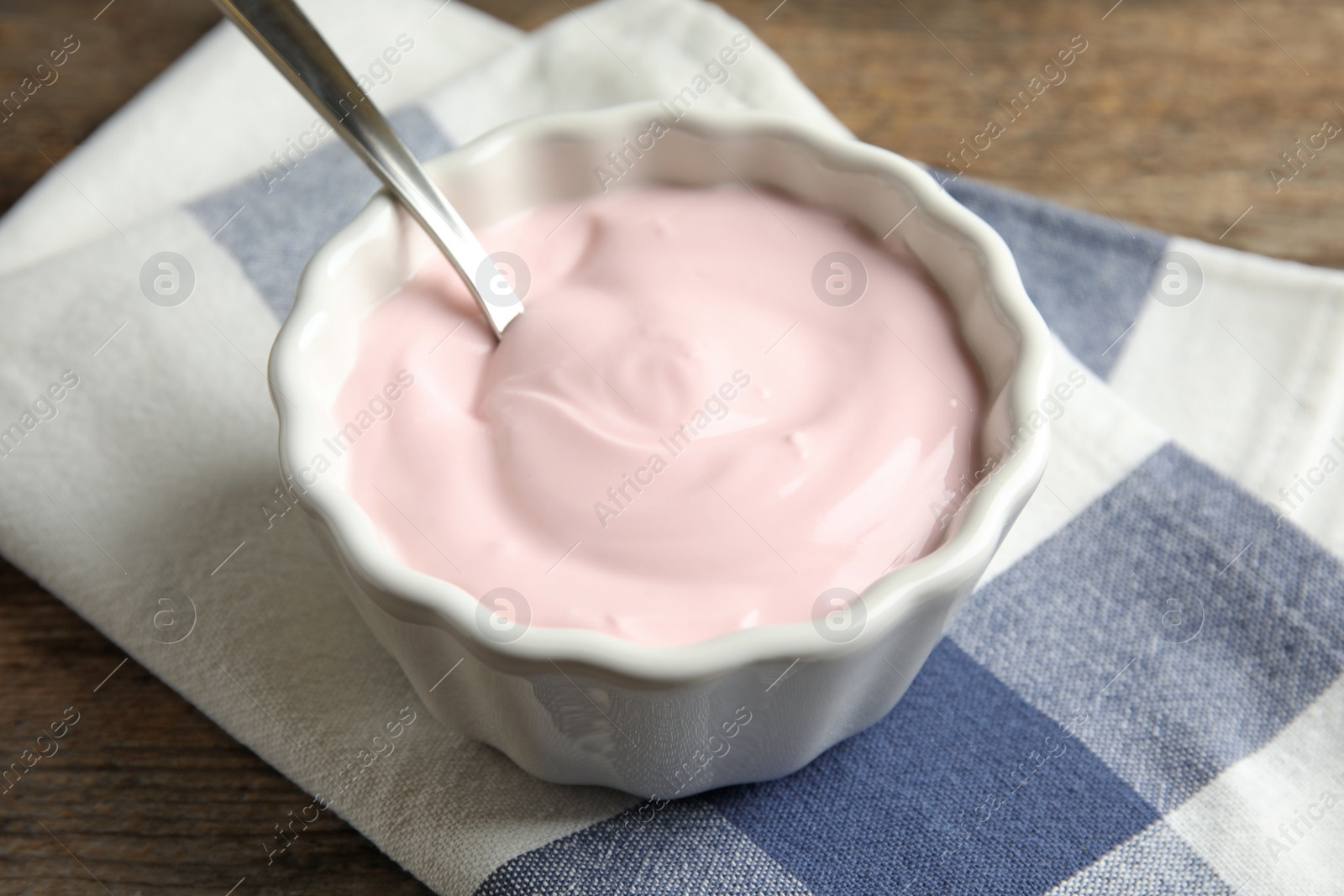 Photo of Bowl with creamy yogurt served on table