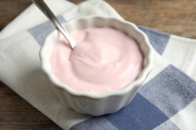 Photo of Bowl with creamy yogurt served on table