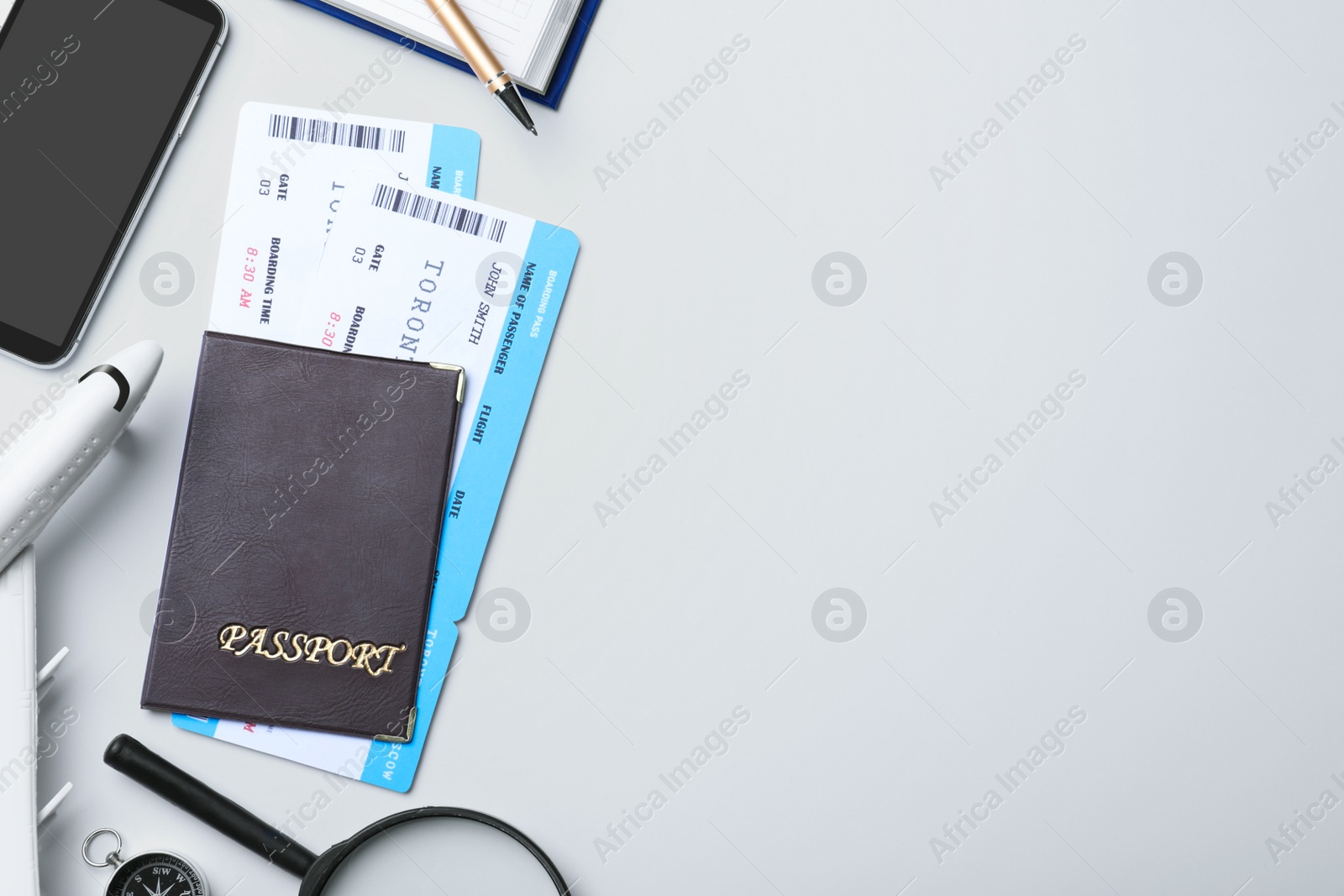 Photo of Flat lay composition with avia tickets and passport on white background, space for text. Travel agency concept