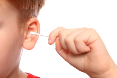 Photo of Little boy cleaning ear with cotton swab on white background, closeup