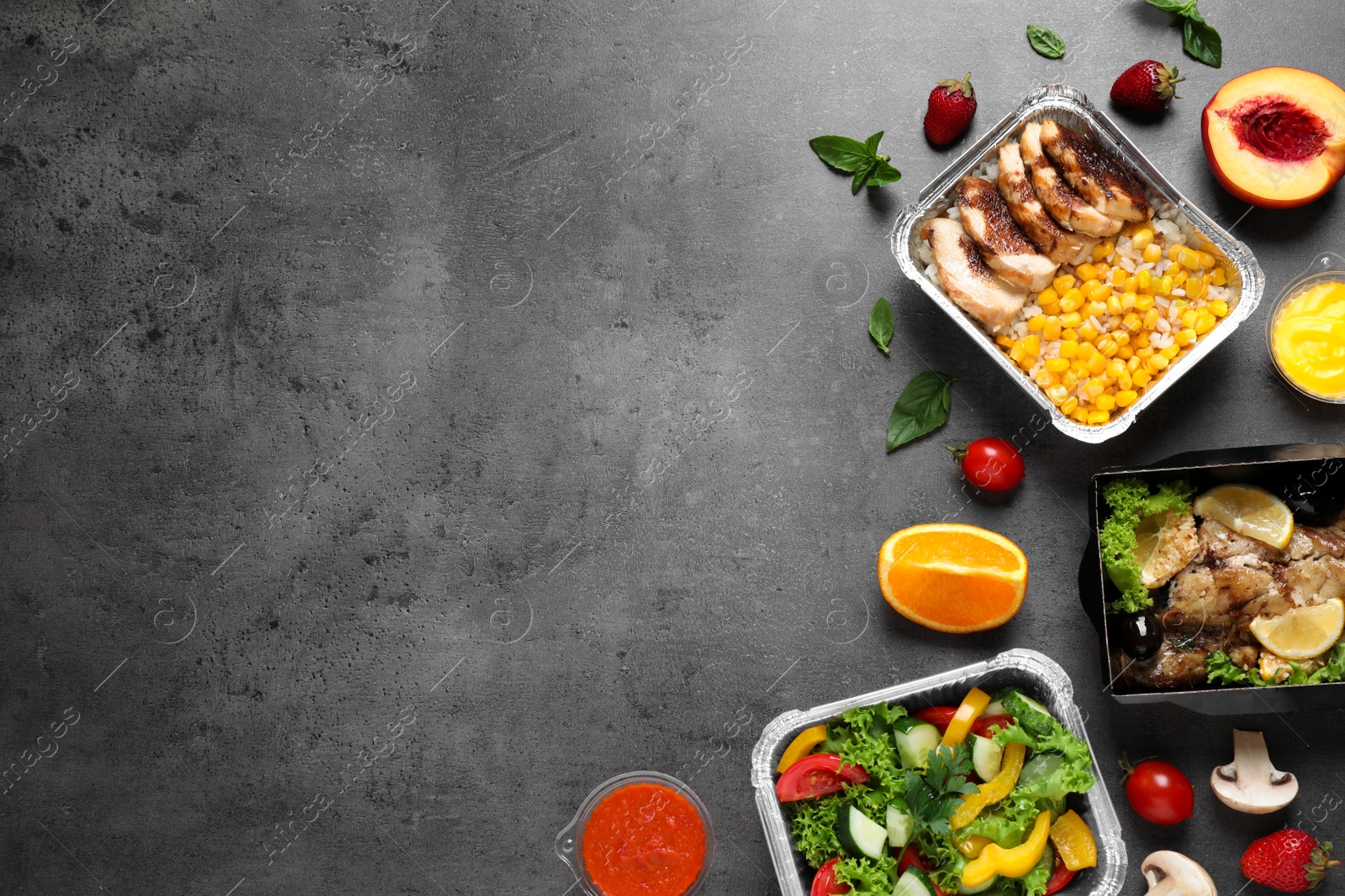 Photo of Lunchboxes on grey table, flat lay. Healthy food delivery