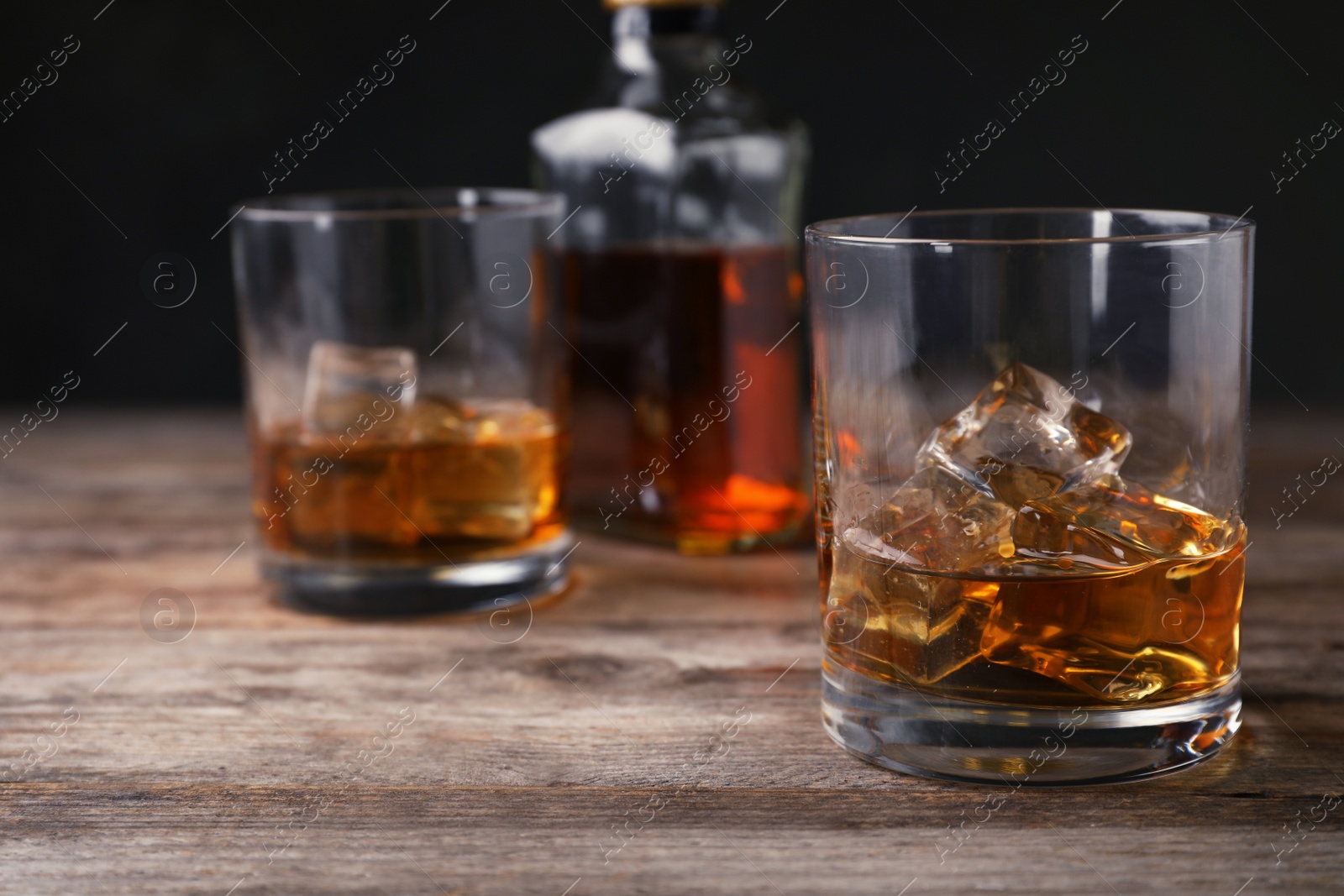 Photo of Composition with glass of whiskey on table. Space for text