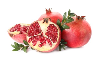 Fresh pomegranates and branches isolated on white