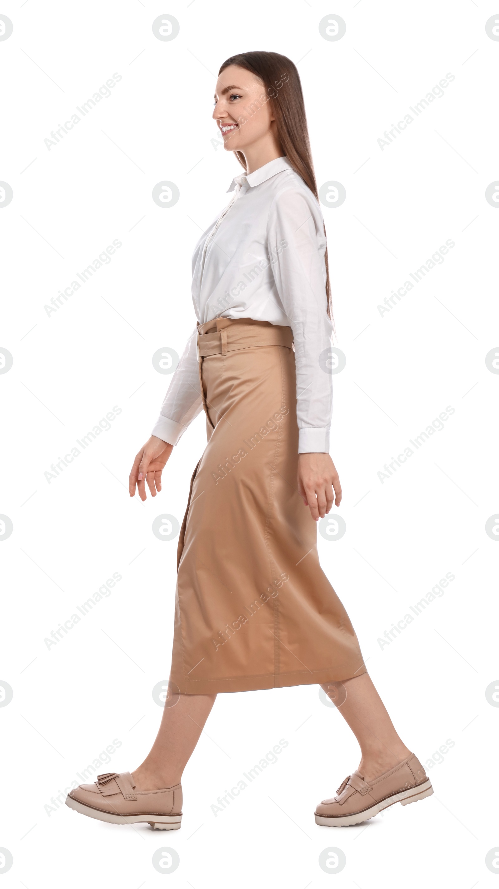 Photo of Young woman in casual outfit walking on white background