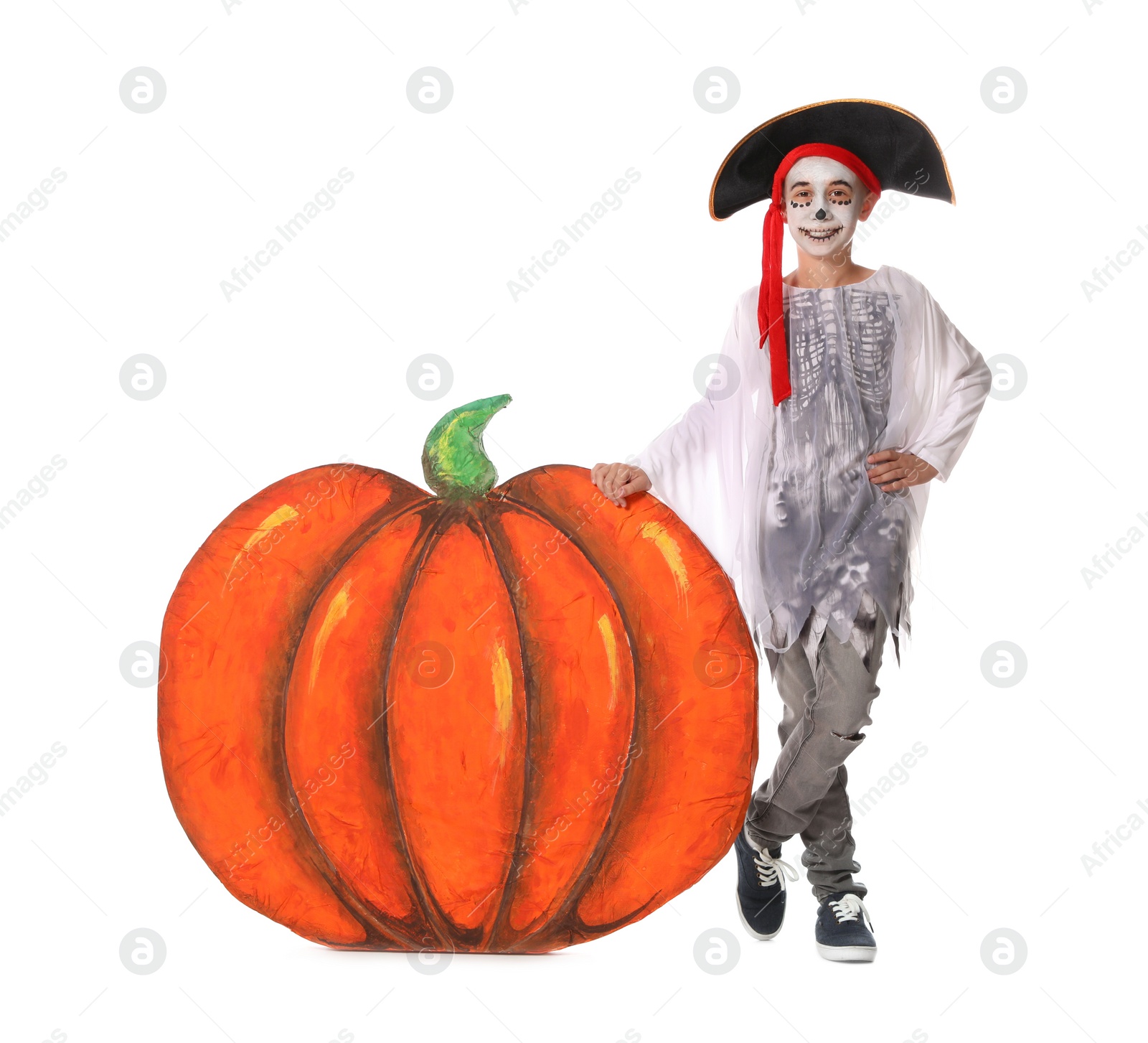Photo of Cute little boy wearing Halloween costume and decorative pumpkin on white background