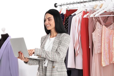 Image of Fashion buyer working with laptop in boutique