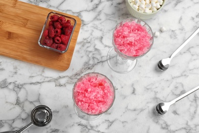 Photo of Flat lay composition with snow ice cream, raspberry and marshmallows on marble background