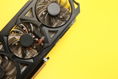 One graphics card on yellow background, top view. Space for text