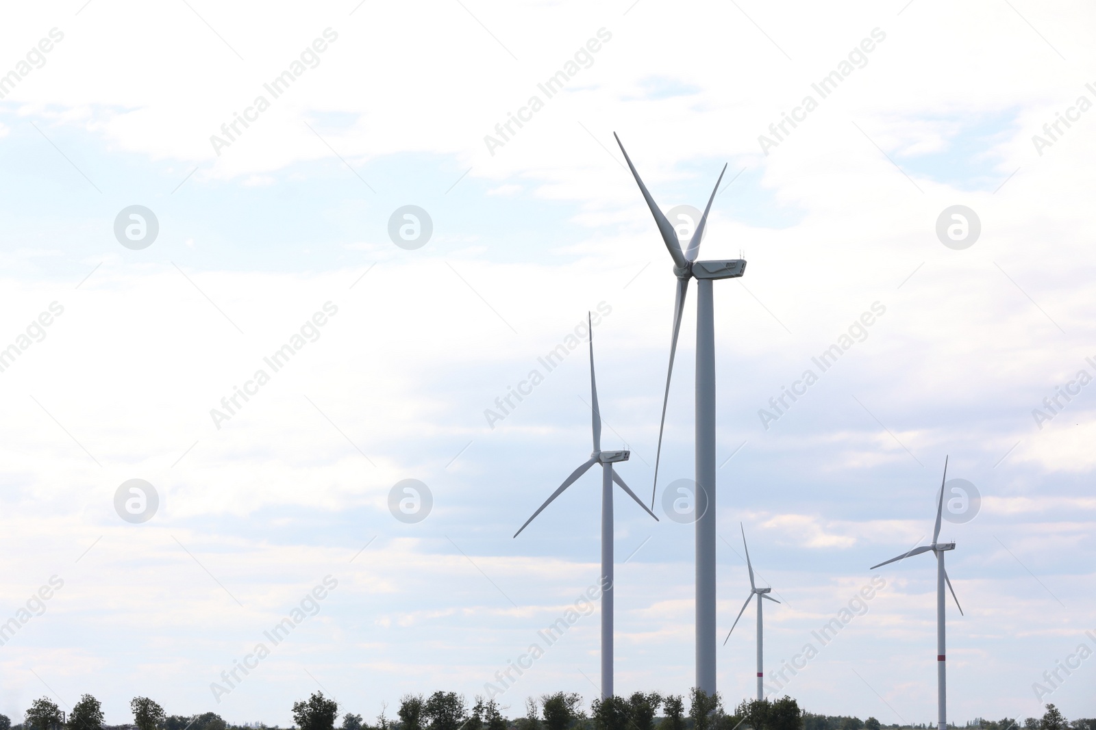 Photo of Beautiful view of field with wind turbines. Alternative energy source