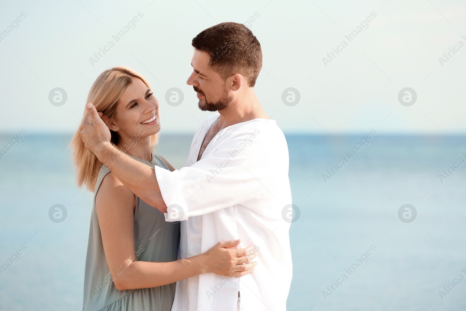 Photo of Happy romantic couple spending time together on beach