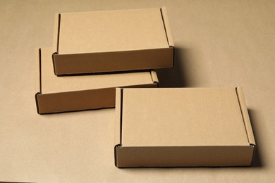 Photo of Many closed cardboard boxes on light brown background