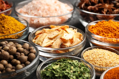 Glass bowls with different spices, closeup view