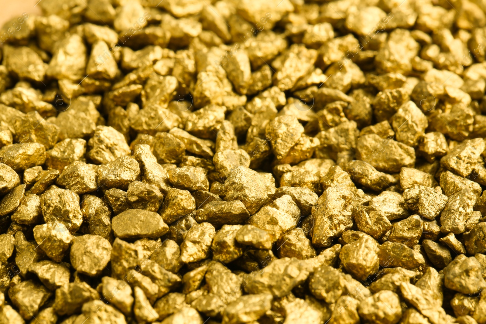Photo of Many shiny gold nuggets as background, closeup