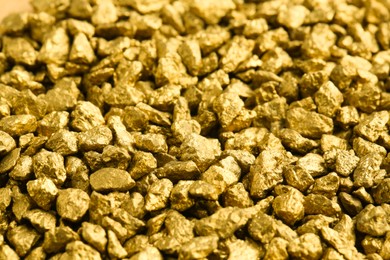 Photo of Many shiny gold nuggets as background, closeup