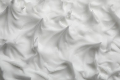 Photo of Texture of white shaving foam as background, closeup