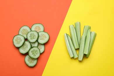 Cut fresh ripe cucumbers on color background, flat lay