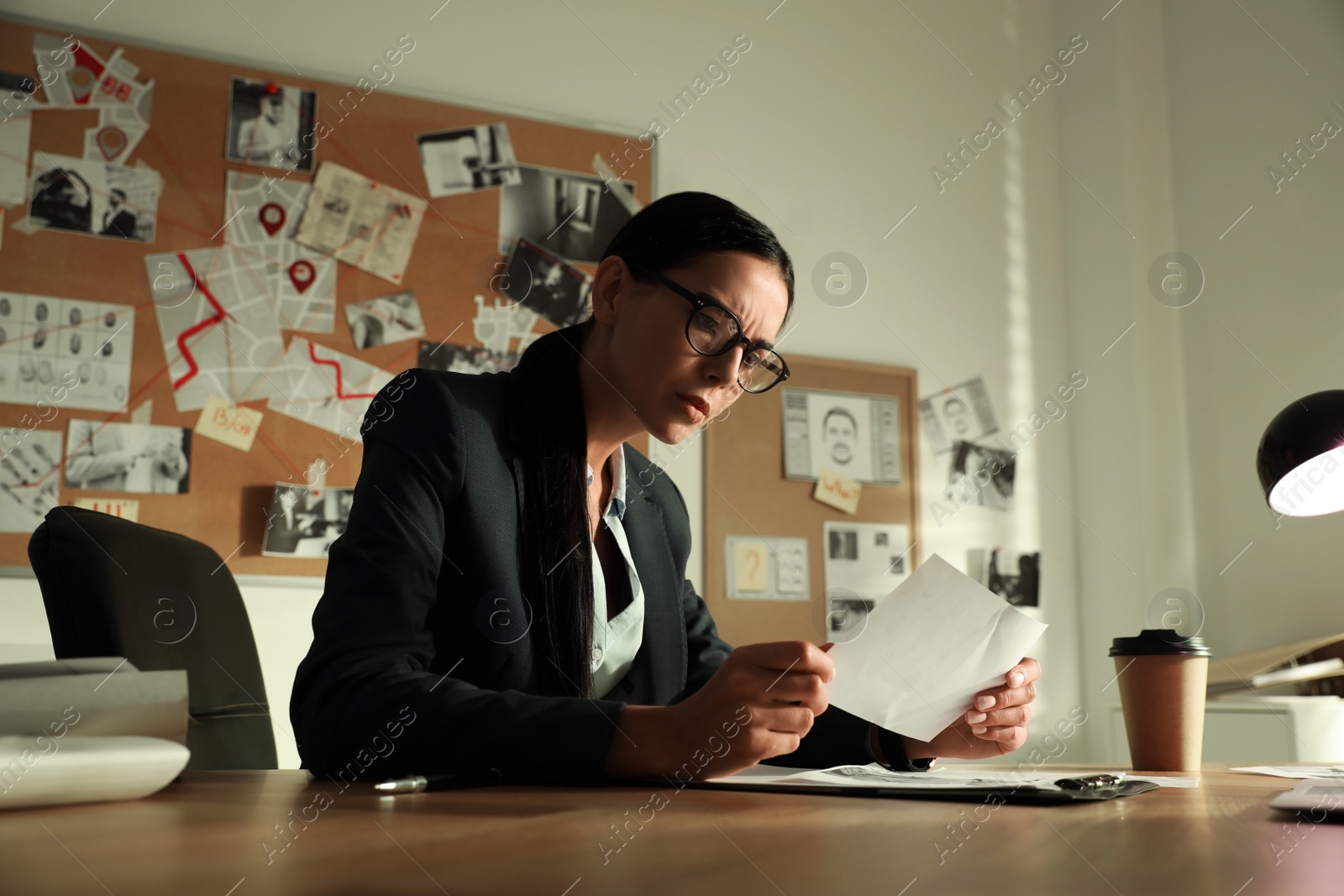 Photo of Detective working at desk in her office