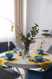 Photo of Beautiful Easter table setting with festive decor indoors