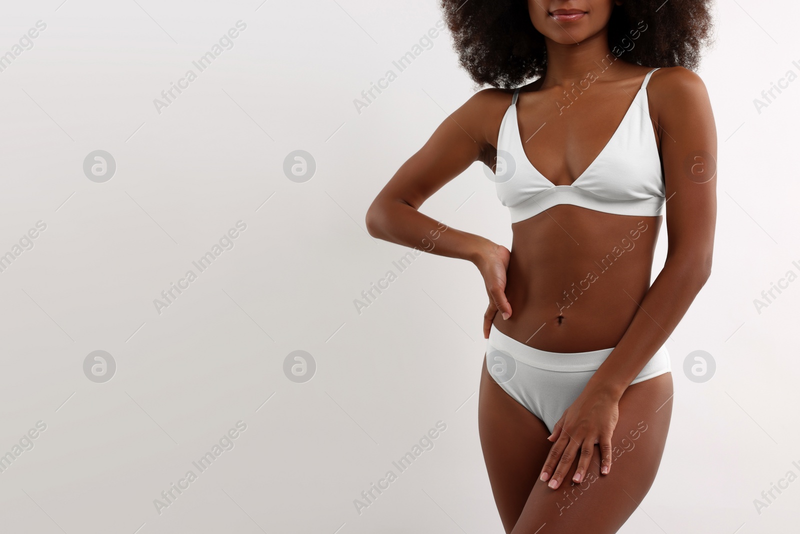 Photo of Woman in stylish bikini on white background, closeup. Space for text