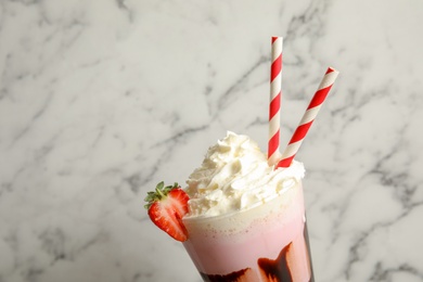 Photo of Glass with delicious milk shake on marble background, closeup