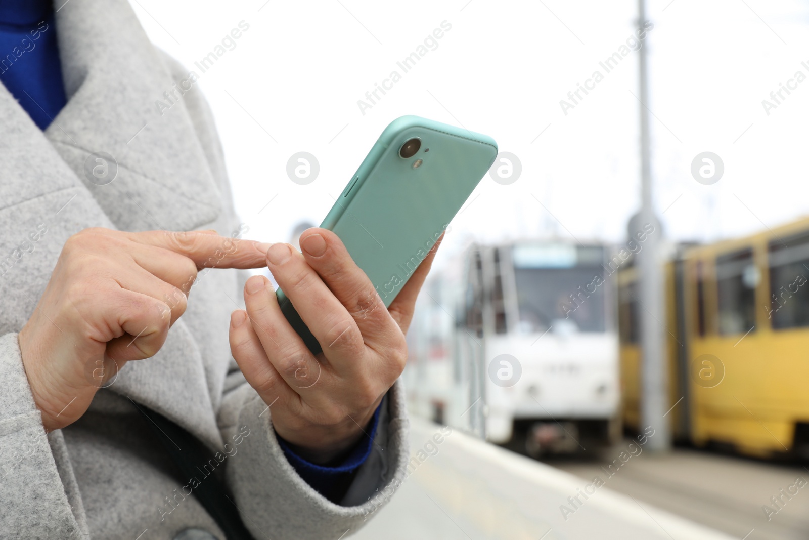 Photo of Woman using smartphone on city street, closeup. Space for text