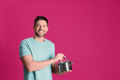 Happy man with pot on pink background. Space for text