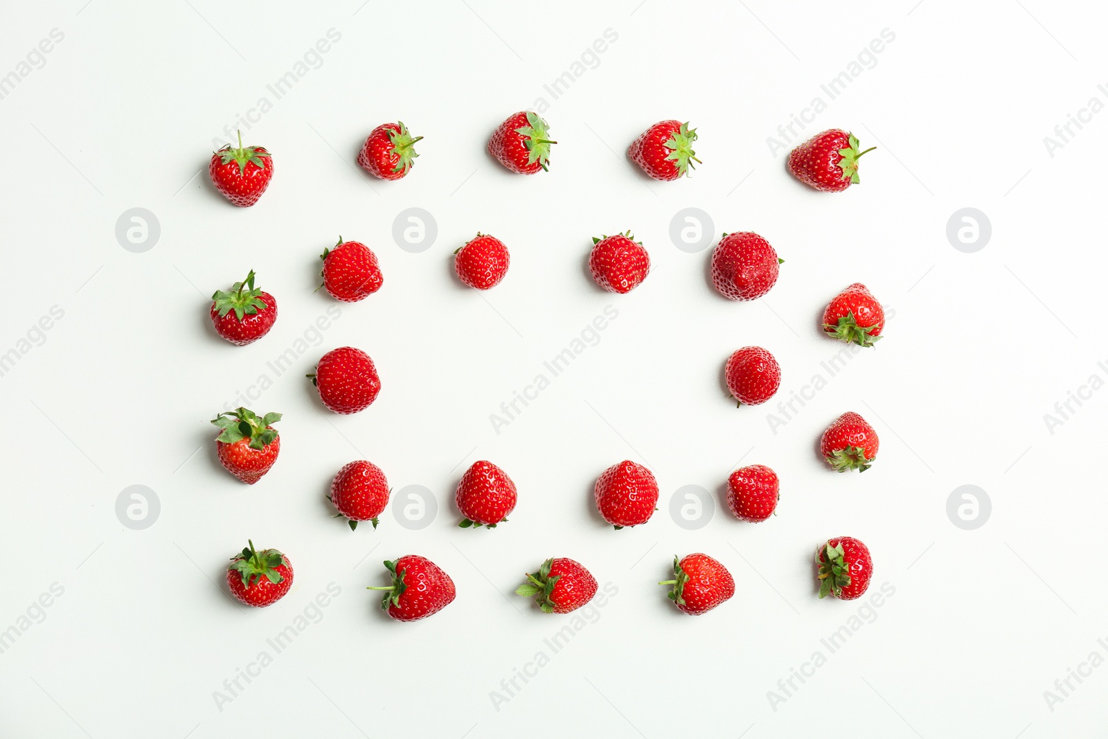 Photo of Flat lay composition with with tasty ripe strawberries on light background