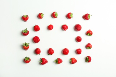 Flat lay composition with with tasty ripe strawberries on light background