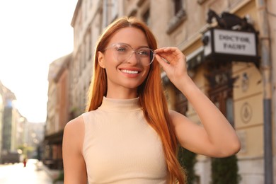 Photo of Portrait of beautiful woman in glasses outdoors