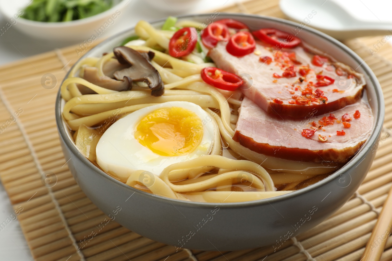 Photo of Delicious ramen in bowl on table, closeup. Noodle soup