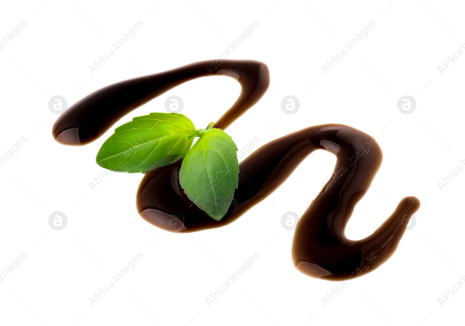 Photo of Balsamic glaze and basil leaves on white background