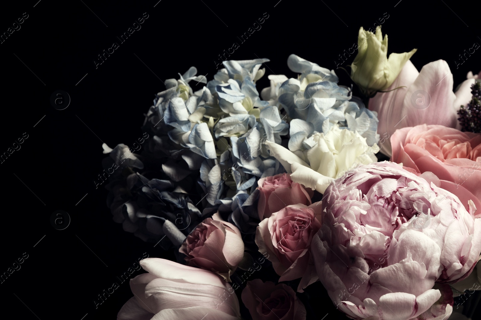 Photo of Beautiful bouquet of different flowers on black background. Floral card design with dark vintage effect