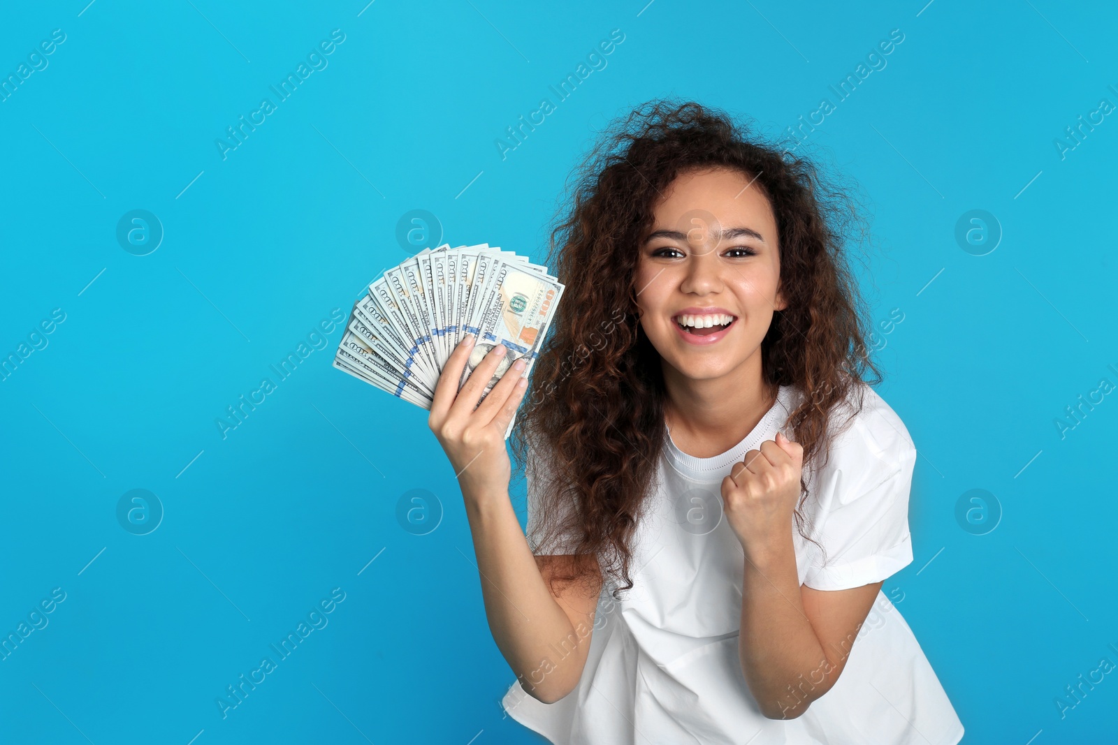 Photo of Young African-American woman with money on color background. Space for text