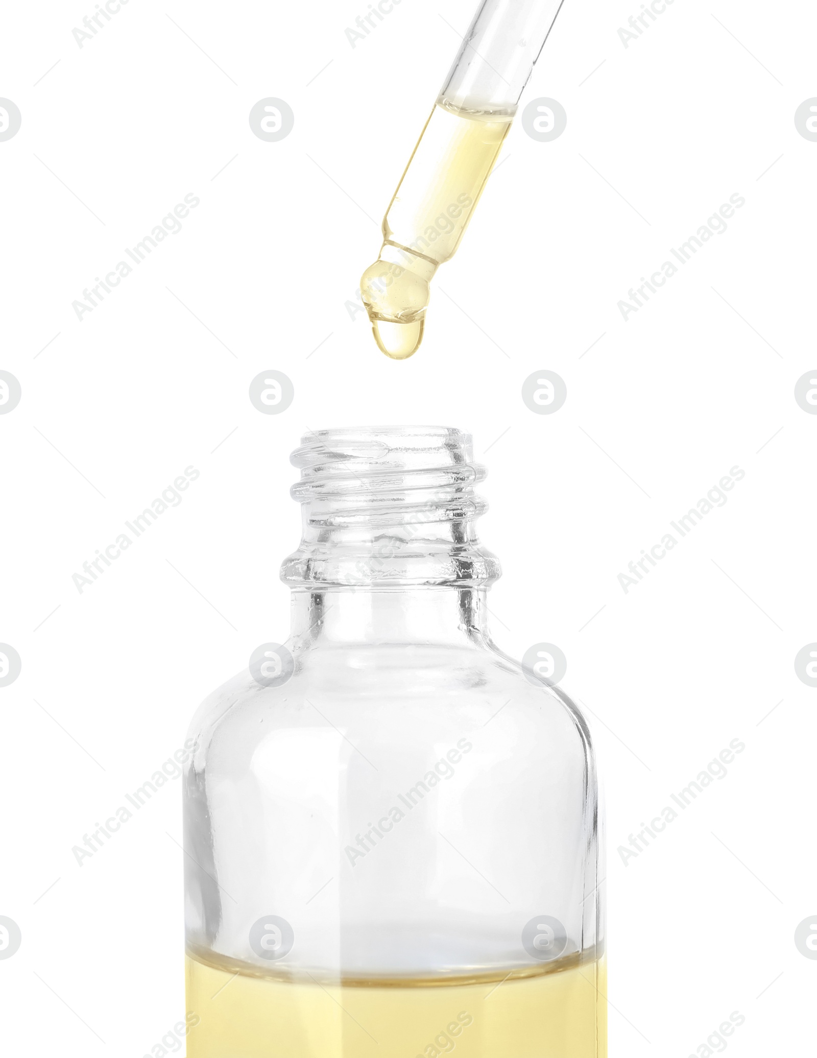 Photo of Dropping herbal essential oil into bottle isolated on white