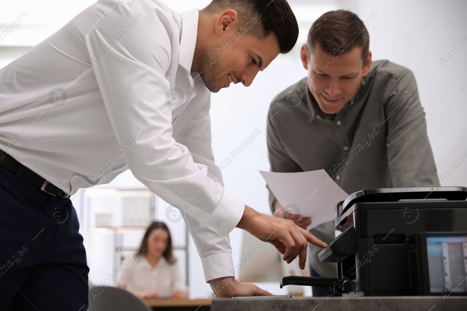 Photo of Employees using new modern printer in office