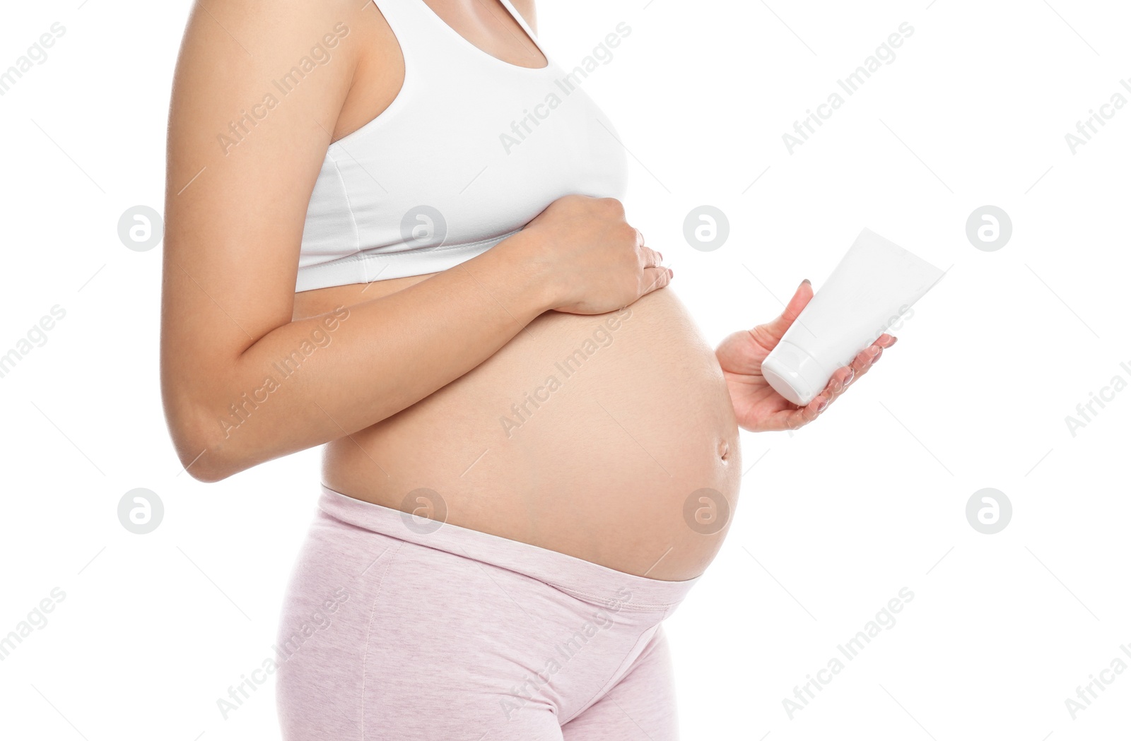 Photo of Pregnant woman holding body cream on white background, closeup