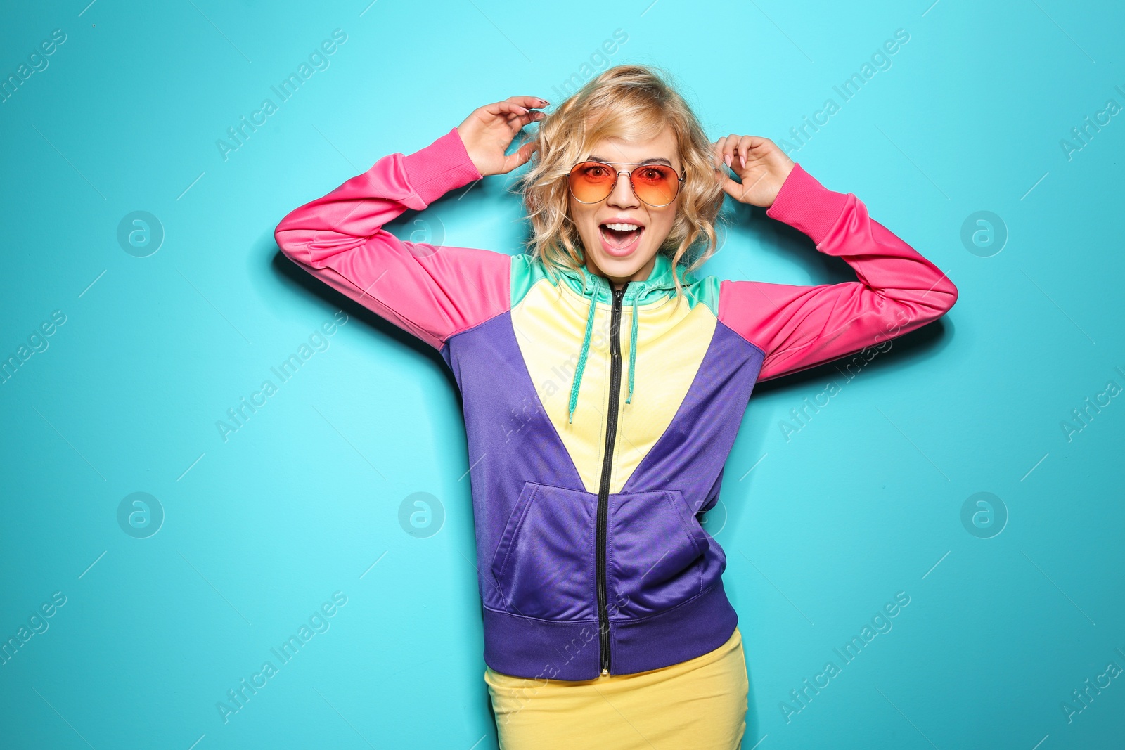 Photo of Emotional stylish young woman on color background