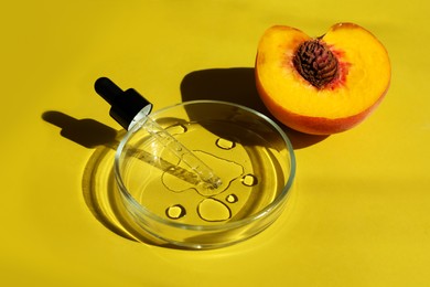 Photo of Petri dishes with pipette and fresh peach on yellow background