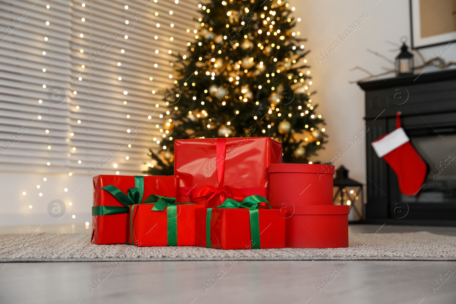 Photo of Beautifully wrapped gift boxes under Christmas tree indoors