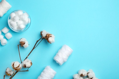 Photo of Flat lay composition with cotton rolls and balls on color background, space for text