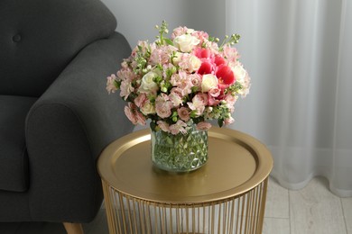 Beautiful bouquet of fresh flowers on coffee table in room