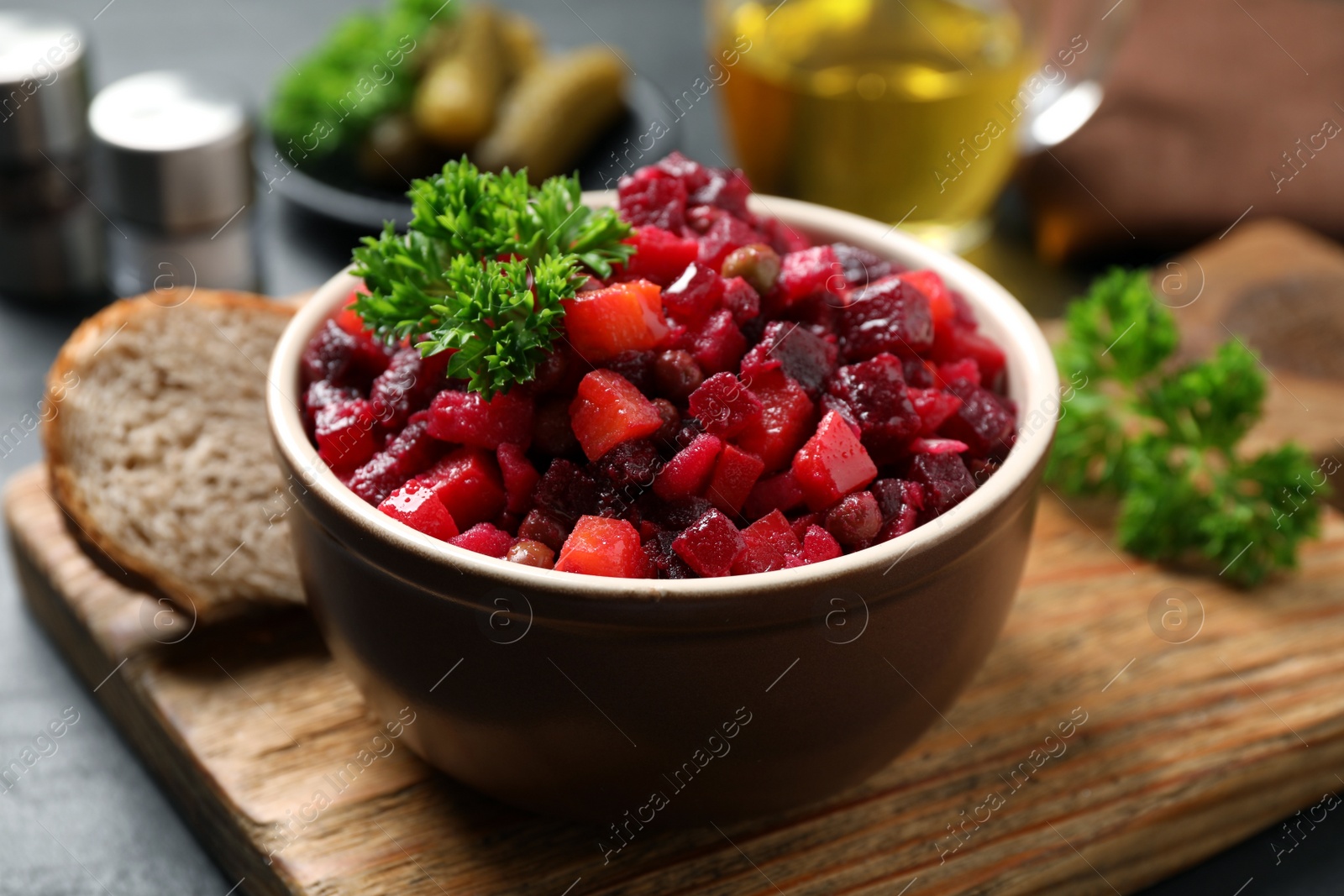 Photo of Traditional Russian salad vinaigrette on wooden board, closeup