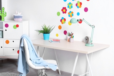 Photo of Modern child room interior with study station
