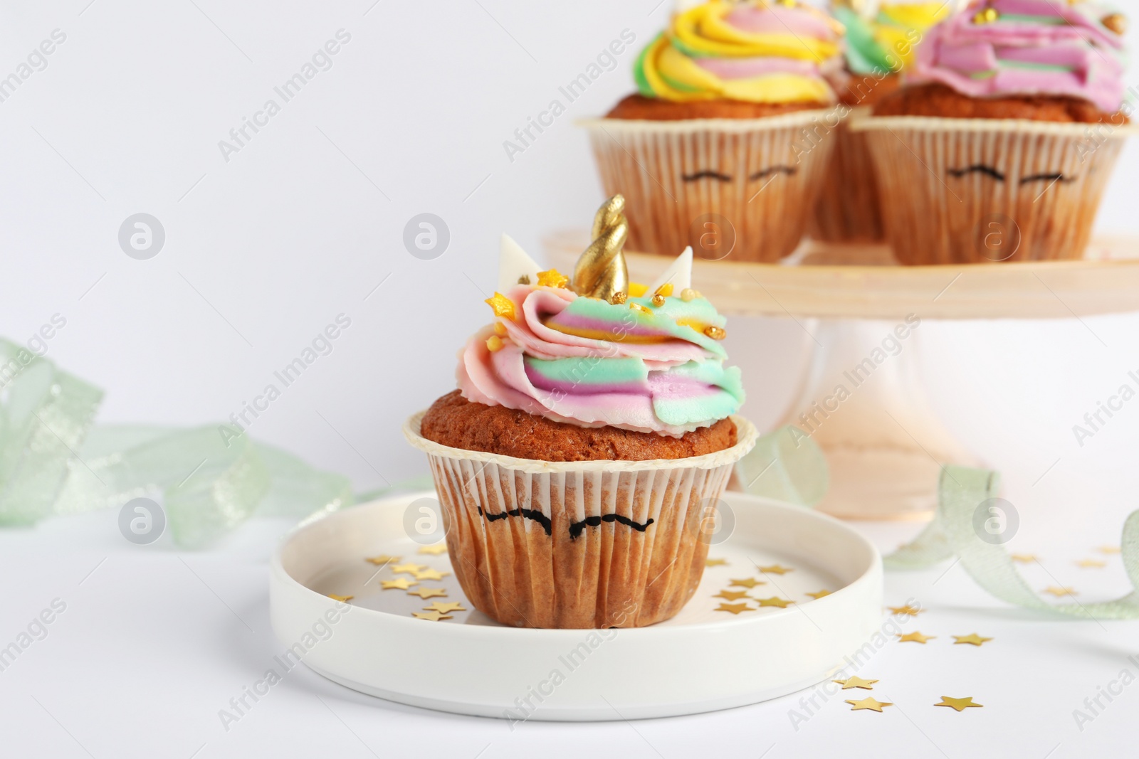 Photo of Cute sweet unicorn cupcakes on white table