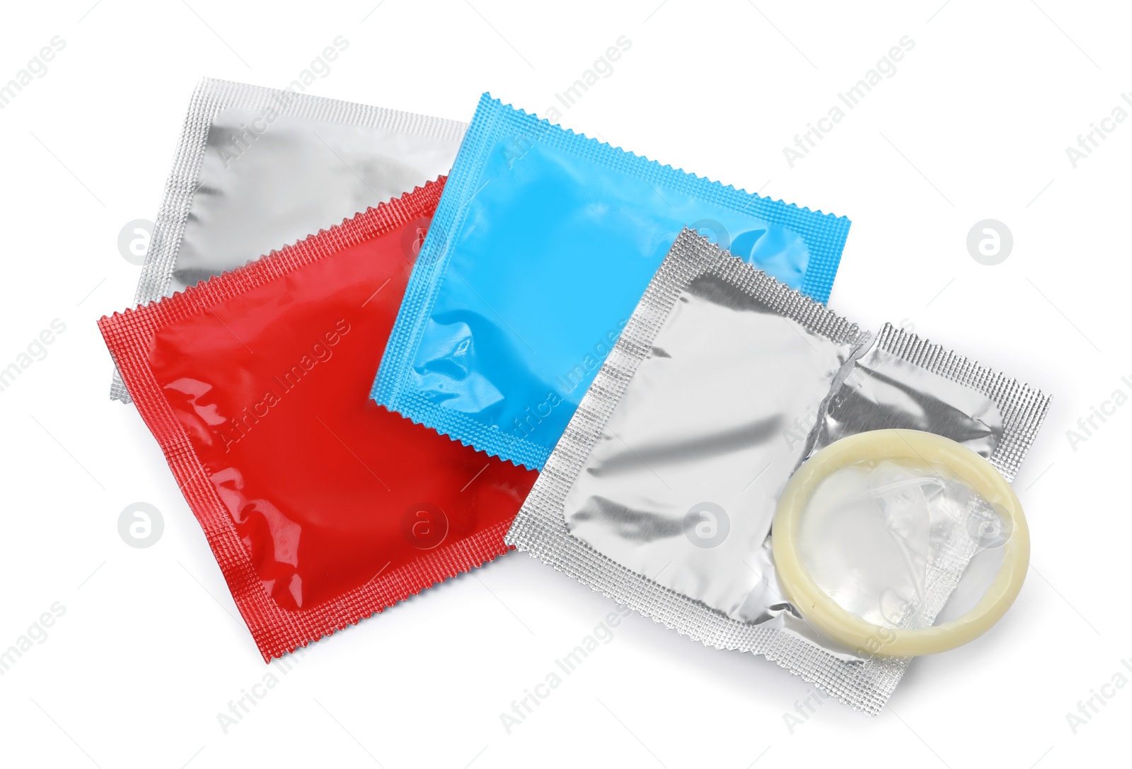 Photo of Packages and unpacked condom isolated on white, top view. Safe sex