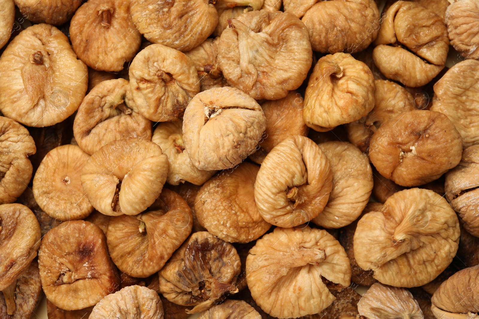 Photo of Many tasty dried figs as background, top view